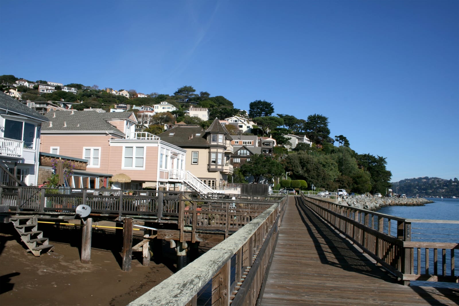 Bridgeway boardwalk and hillside homes along the Sausalito waterfront on San Francisco Bay